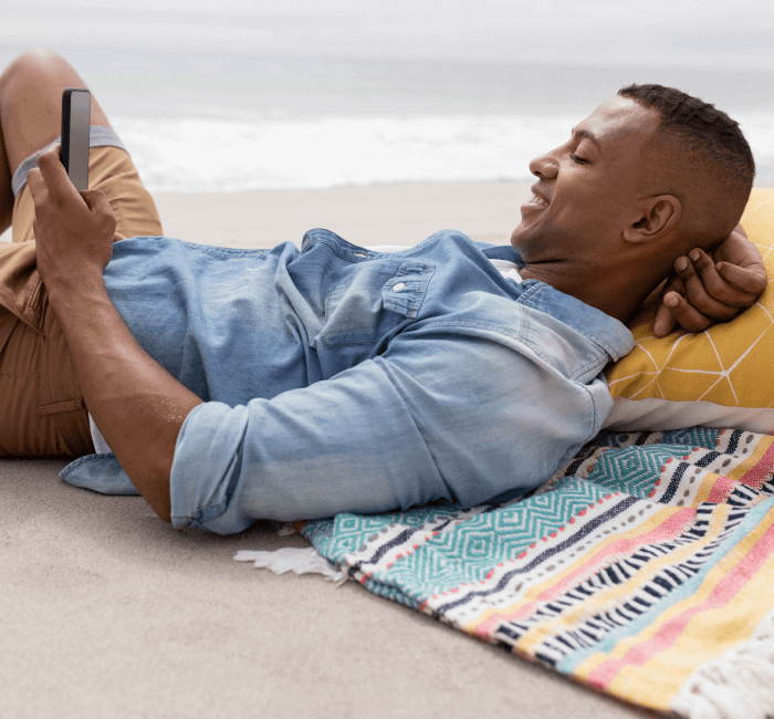 Man relaxing and smiling at phone
